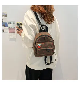 Chic brown corduroy mini backpack featuring cute strawberry print for school and travel.