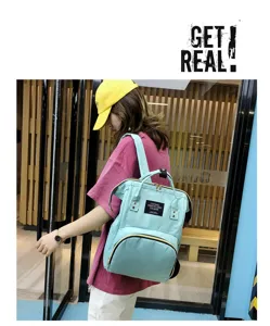 Stylish multi-functional waterproof diaper backpack with large capacity and dual handles.