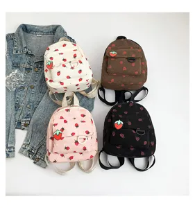 Corduroy strawberry print backpack showing four colors and sweet college style details.