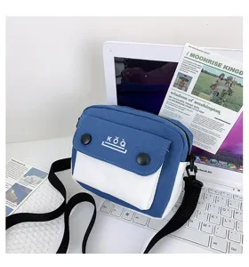Canvas crossbody bag for women, stylish color block small shoulder bag with front pocket design.