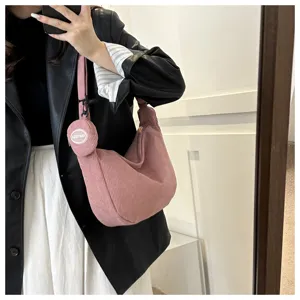 Casual pink corduroy shoulder bag with small pouch detail, minimalist crossbody bag for daily wear.