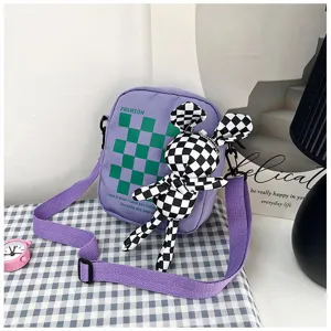 Purple canvas crossbody bag featuring green plaid pattern and cute checkered rabbit pendant.