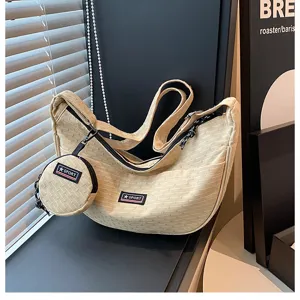 Casual Japanese canvas dumpling crossbody shoulder bag with coin purse, large capacity.