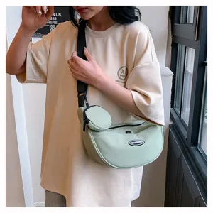 Minimalist crescent crossbody bag for women and men, lightweight canvas shoulder chest bag.