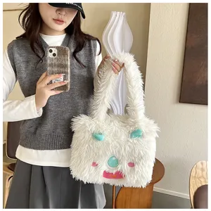 Plush monster tote bag detail view, fluffy white faux fur with cute cartoon face, soft shoulder bag.