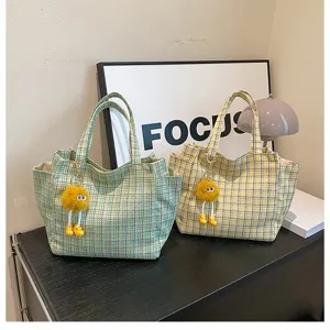 Plaid tote bag large capacity shoulder handbag with cute plush charm for women daily use.
