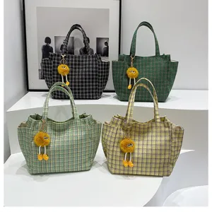 Plaid tote bag with cute plush ball pendant, casual large capacity shoulder bag for women.