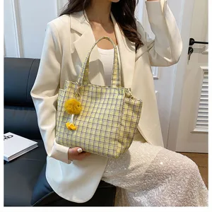 Yellow plaid tote bag for women stylish shoulder bag with cute fluffy charm for daily use.