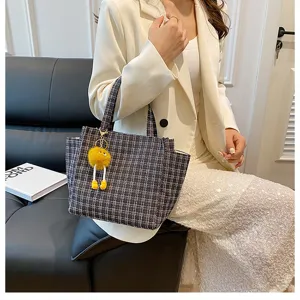 Stylish tweed shoulder bag for women, large capacity tote with cute plush charm, chic design.