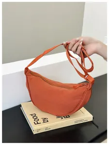 Versatile orange nylon crescent bag, stylish dumpling shoulder crossbody bag for women.