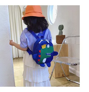 Detail view of the cute kids dinosaur backpack featuring a playful green cartoon design and straps.