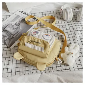 Sweet style nylon crossbody bag with cute bear ears and plush pendant for daily student use.