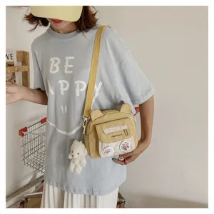 Cute nylon crossbody bag for women, sweet style shoulder bag with cute bear ears and pendant.