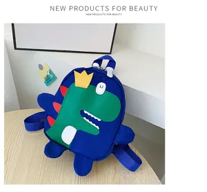 Cartoon dinosaur kids backpack detail shot, cute blue school bag with green front pocket.