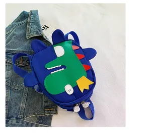 Cute cartoon dinosaur kids backpack detail, blue and green canvas toddler school bag design.