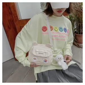 Cute nylon crossbody bag with bear ears and plush pendant, sweet girl shoulder bag for daily use.