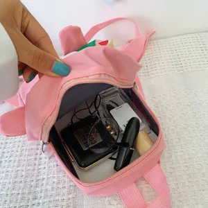 Cute pink cartoon dinosaur kids backpack with spacious interior, ideal for boys and girls.
