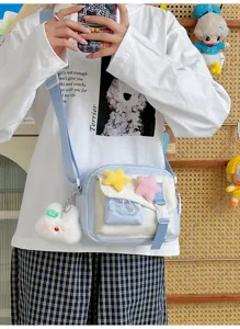 Detail view of the cute canvas crossbody bag with plush star charm and sweet rabbit pendant.