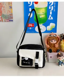 Casual black and white canvas crossbody bag for women, stylish student shoulder bag for daily use.