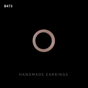 Simple resin circle detail shot in soft nude pink, smooth and elegant fashion jewelry piece.