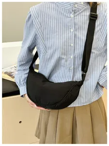 Classic black crescent shoulder bag for women, versatile nylon dumpling crossbody bag.