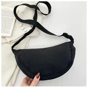 Detailed view of black nylon crescent shoulder bag with adjustable strap, casual design.