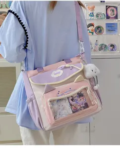 Cute pastel ita bag with transparent window, cat ears, and fluffy cloud pendant for girls.