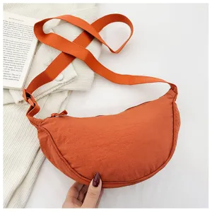 Orange nylon crescent shoulder bag detail, zipper closure with adjustable strap view.