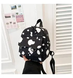 Schwarzer und weißer Kuh-Print Kordstoff Mini Rucksack trendige lässige Umhängetasche