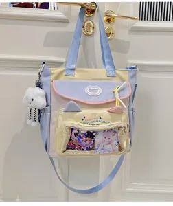 Details of the pastel colorway canvas itabag featuring cute cat ears and a clear window.
