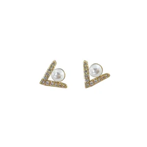 Detailed view of geometric V-shaped crystal pearl earrings, showcasing exquisite craftsmanship.