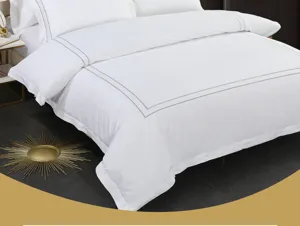 Detailed view of luxury white cotton bedding set featuring elegant grey embroidered border design.