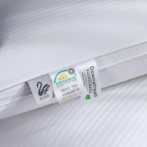 White striped down pillow detail shot with OEKO-TEX certified label and soft cotton fabric.