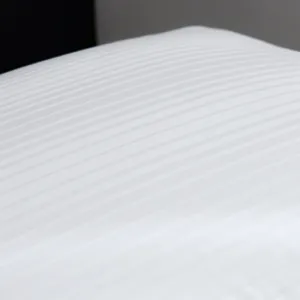 White striped cotton pillow detail view showing soft fabric texture and clean modern look.