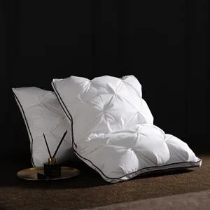 White goose down pillow detail, quilted design with dark piping for luxury hotel and home use.