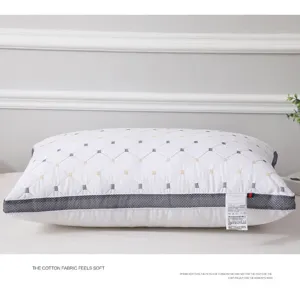 White quilted hotel pillow detail with breathable mesh border and comfortable cotton filling.