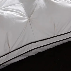 White cotton down pillow core detail hotel household bed pillow with pleated design and piping.