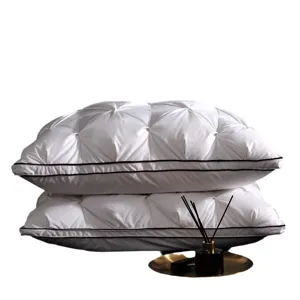 Luxurious white goose down pillow set with pleated design and elegant piping for hotel luxury.