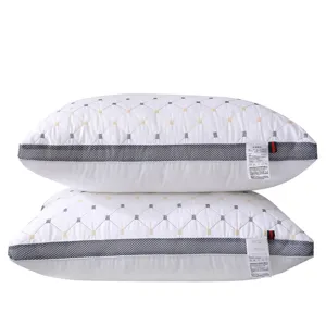 Luxury hotel pillow pair with breathable mesh border and diamond quilted white fabric design.