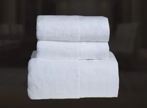 Pure white hotel cotton towel set texture detail, soft and absorbent plush fabric for bathroom use.