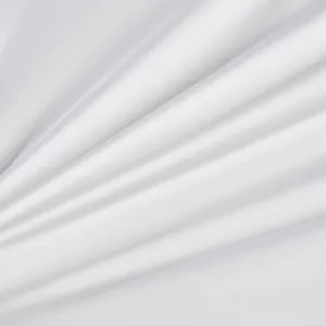 White sateen fabric detail close up showing soft draping and fine texture for bedding.