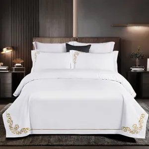 Luxury white cotton 4-piece bedding set with elegant gold embroidery, hotel style and soft feel.