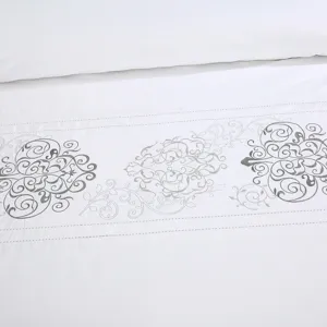 White cotton sateen hotel bedding set detail shot with elegant grey embroidery pattern.