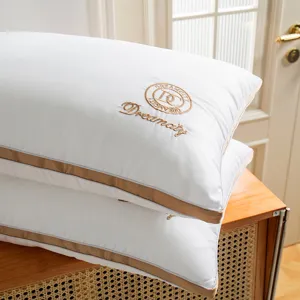 Luxury hotel style white bed pillows set with gold piping and elegant embroidery design for home