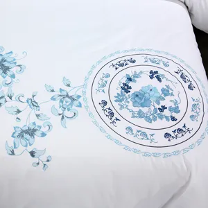 White cotton sateen bedding set duvet cover featuring elegant blue floral embroidery.