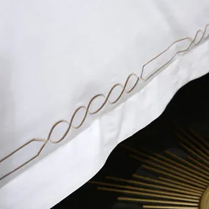 White hotel bedding set 4-piece cotton duvet cover with elegant brown geometric embroidery close up