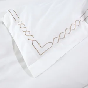 White hotel bedding set with elegant embroidered geometric border, premium cotton.