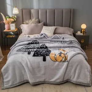 Cozy gray plush blanket scene featuring cute fox and tree prints for winter home decor style.