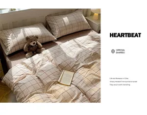 Close-up detail of cozy cotton plaid bedding set with warm tone and soft texture.