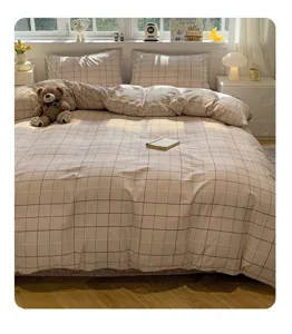 Cozy cotton plaid bed sheet set detail view, warm bedroom decor style, soft textile texture.